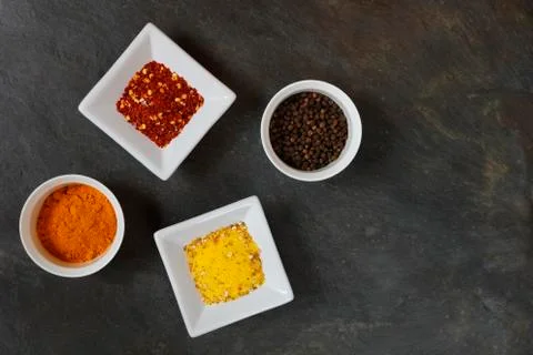 Various spices on slate background Stock Photos