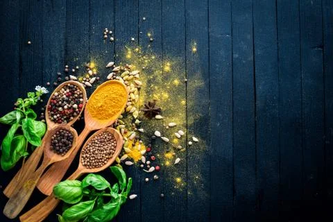 Various spices spoons on stone table. On a wooden board. Top view. Free space Stock Photos