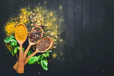 Various spices spoons on stone table. On a wooden board. Top view. Free space Stock Photos