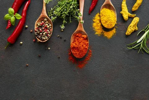 Various spices spoons on stone table. Top view with copy space Stock Photos