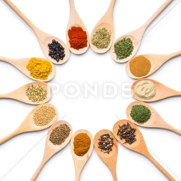 Various spices in wooden spoons. Stock Photos
