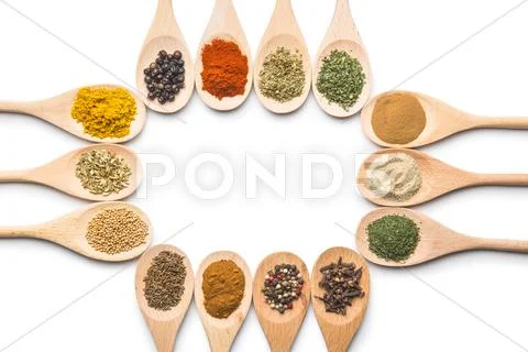 Various spices in wooden spoons. Stock Photos
