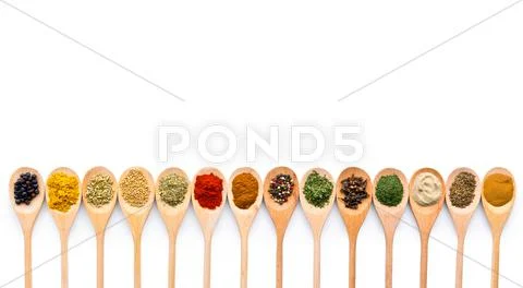 Various spices in wooden spoons. Stock Photos
