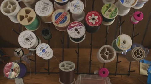 Various spool Of threads arranged on table Stock Footage 83885277