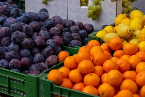Various stacks of fruit lie on the table for sale at the market Stock Photos