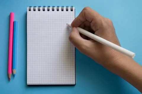 Various stationery and notebook on a two color background. Stock Photos