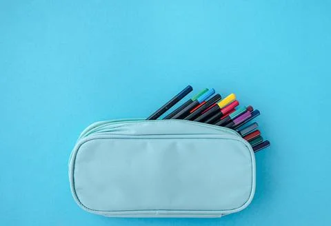 Various stationery tools in pencil case on blue background, school supplies.. Stock Photos