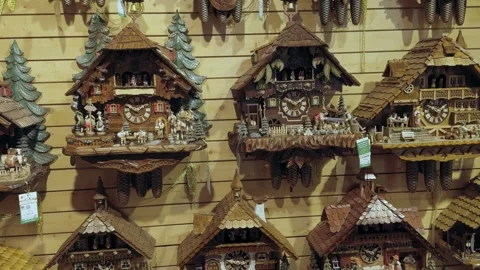 Various styles and sizes of Cuckoo clocks for sale in shop. Stock Footage 289558893