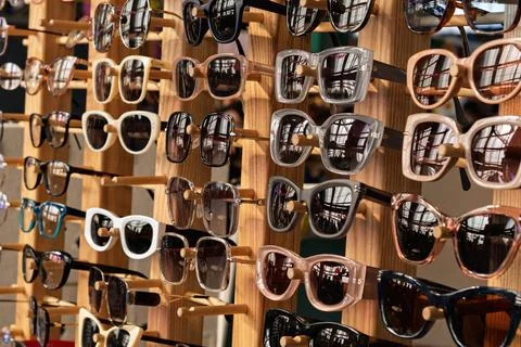 Various stylish sunglasses with different frames are displayed on a wooden .. Foto stock