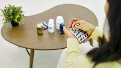 Various Supplement Bottles and Vitamins on Table at Home Stock-Footage 338371499