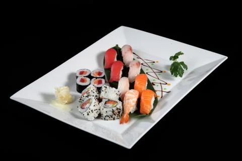 Various sushi and sashimi on rectangular plate Stock Photos