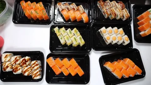 Various sushi on disposable plates in a restaurant. Close-up. Stock Footage 322215485