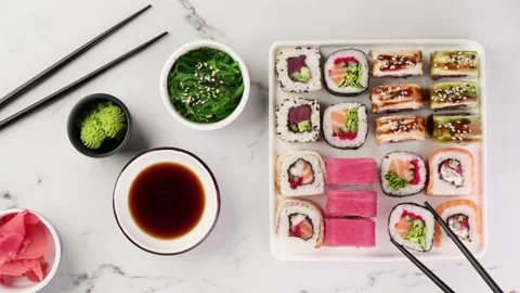 Various sushi rolls are served on a plate on a white stone background Stock-Footage 149054910