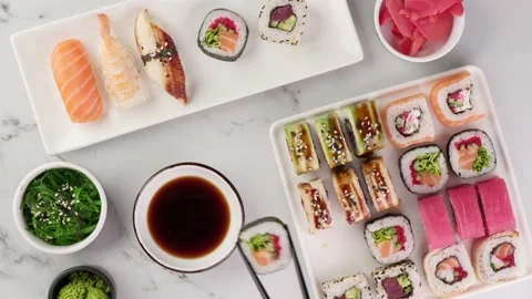 Various sushi rolls are served on a plate on a white stone background Stock Footage 151644770