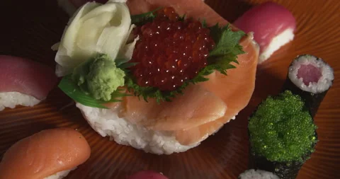 Various sushi rolls placed on round ceramic plate Stock Footage 133965924