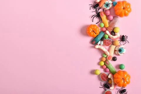 Various sweets on a pink background. Happy Halloween. Copy space. Flat lay, t Stock Photos