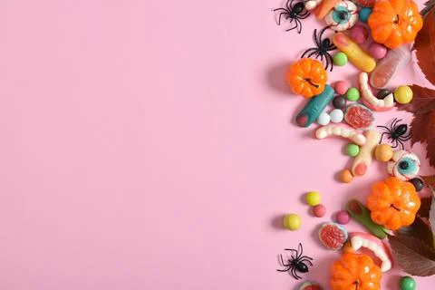 Various sweets on a pink background. Happy Halloween. Copy space. Flat lay, t Stock Photos