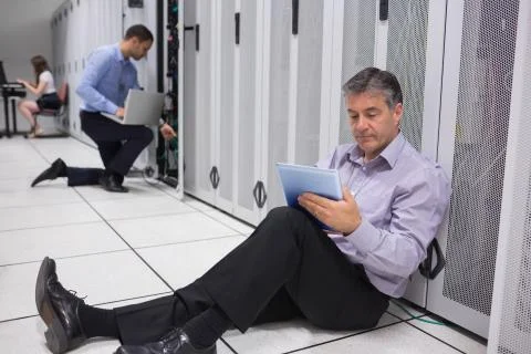 Various technicians working on servers Stock Photos