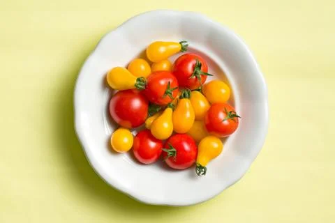 Various tomatoes on plate Stock Photos