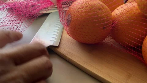 Various Transitions Pulling Knife To Cut Orange Stock Footage