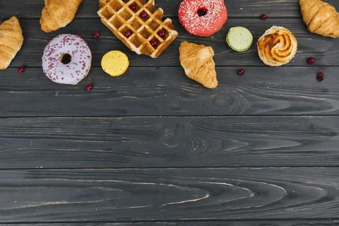 Various type sweets baked items wooden table Stock Photos