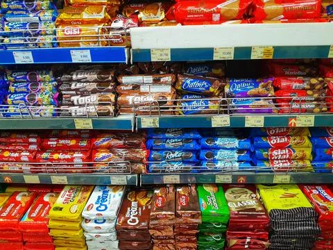 Various types and brands of biscuits snacks on supermarket. Stock Photos