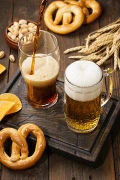 Various types of beer - light and dark and snack variety. Stock Photos