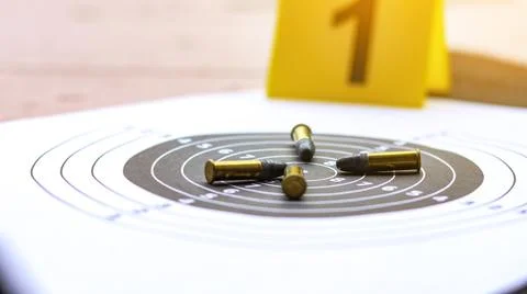 Various types of bullets displayed on shooting target with blur number 1, s.. Stock Photos