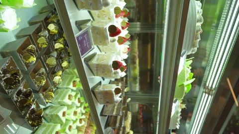 Various types of cakes displayed on the shelf and selling in the bakery shop. 動画素材 271139220