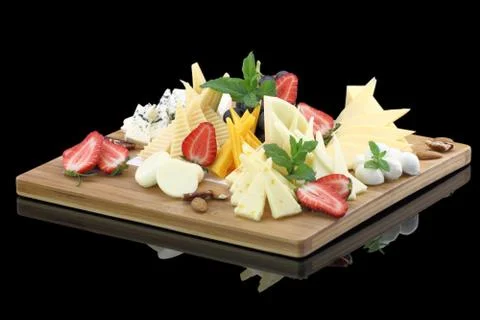 Various types of cheese on a cheese platter Stock Photos