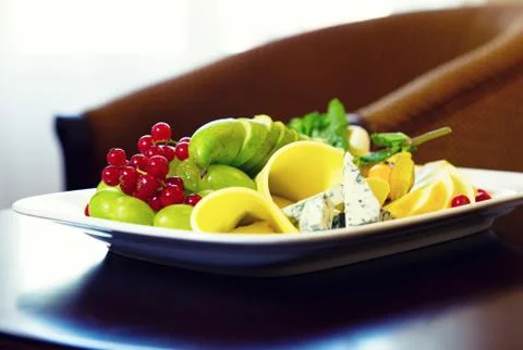 Various types of cheese, grapes and redcurrant closeup composition Stock Photos