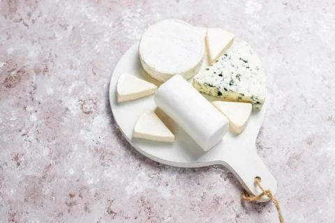 Various types of cheese on light brown background,top view Stock Photos