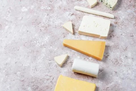 Various types of cheese on light brown background,top view Stock Photos