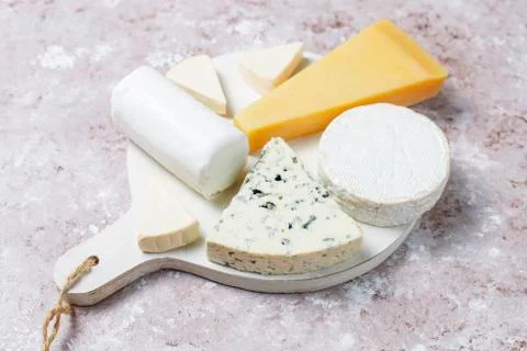 Various types of cheese on light brown background,top view Stock Photos