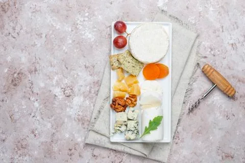 Various types of cheese on light brown background,top view Stock Photos