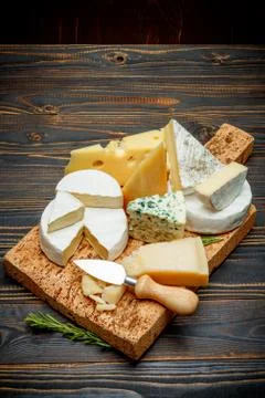 Various types of cheese - parmesan, brie, roquefort, cheddar Stock Photos