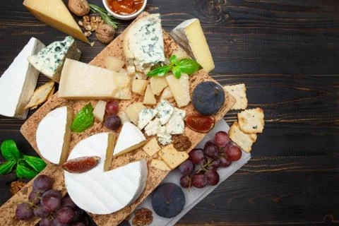 Various types of cheese - parmesan, brie, roquefort, cheddar Stock Photos