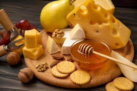 Various types of cheese on a rustic table Foto stock