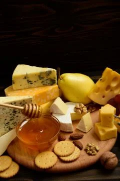 Various types of cheese on a rustic table Foto stock