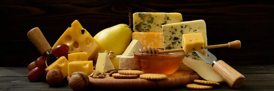 Various types of cheese on a rustic table Foto stock