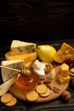 Various types of cheese on a rustic table Foto stock