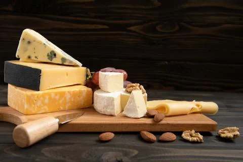 Various types of cheese on a rustic table Foto stock