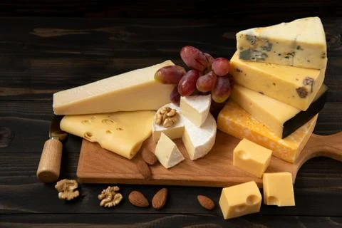 Various types of cheese on a rustic table Foto stock