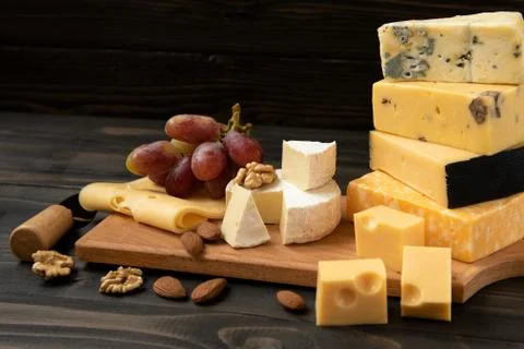 Various types of cheese on a rustic table Foto stock