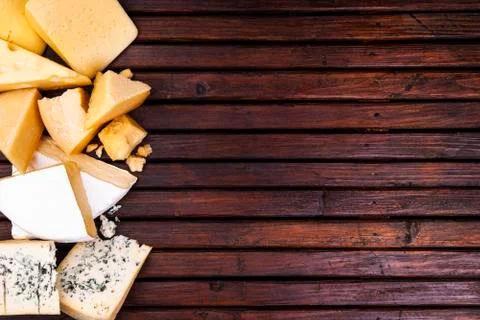 Various types of cheese on rustic wooden table, top view Foto stock