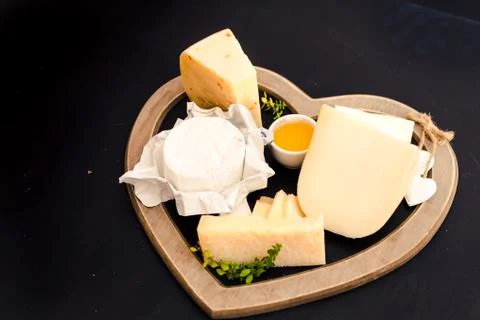 Various types of cheese on a stand in the shape of a heart, concept elegant life Stock-Fotos