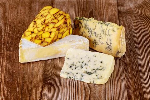 Various types of cheese on wooden background. Stock Photos
