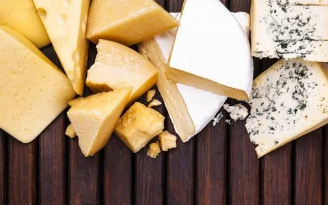 Various types of cheese on wooden table, top view Stock Photos