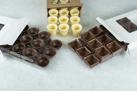 Various types of chocolates in different shapes inside boxes. Stock Photos