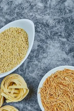 Various types of dry pasta on the marble background Stock Photos